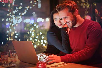 Man and woman on a laptop